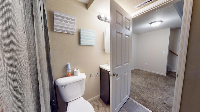 917 4th Ave, Minot, ND 58703 - bathroom with vanity, toilet, and baseboards