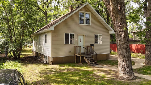 917 4th Ave, Minot, ND 58703 - rear view of house with a chimney