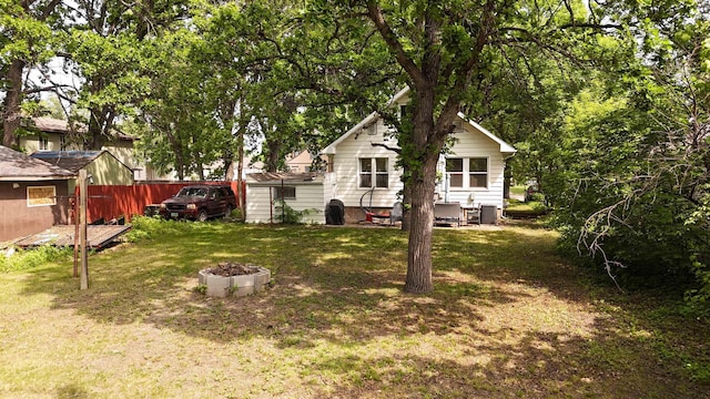 917 4th Ave, Minot, ND 58703 - back of house featuring a lawn and a fire pit