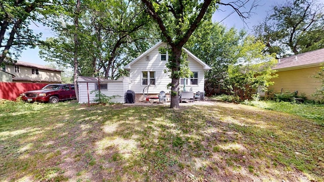 917 4th Ave, Minot, ND 58703 - rear view of property featuring a lawn and a patio area