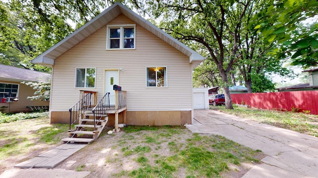 917 4th Ave, Minot, ND 58703 - view of front of house with an outdoor structure and a garage