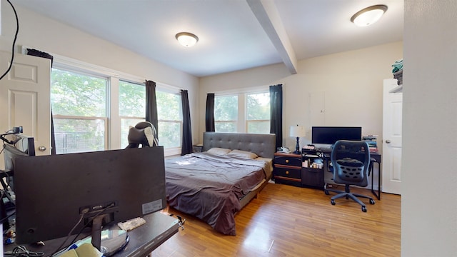 917 4th Ave, Minot, ND 58703 - bedroom with beam ceiling, light wood-style floors, and an office area