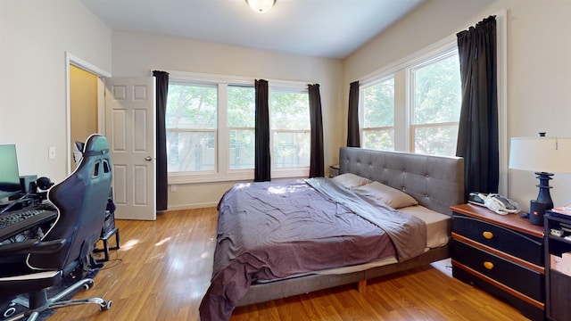 917 4th Ave, Minot, ND 58703 - bedroom featuring light wood-type flooring and baseboards