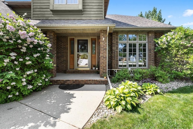 3304 12th St, Minot, ND 58701 - entrance to property with brick siding, covered porch, and roof with shingles