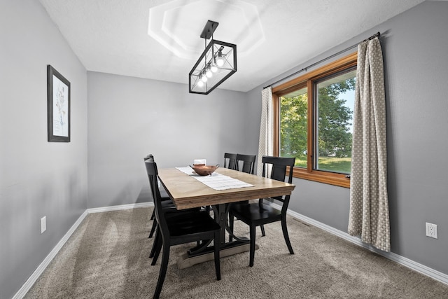 3304 12th St, Minot, ND 58701 - dining space featuring carpet and baseboards