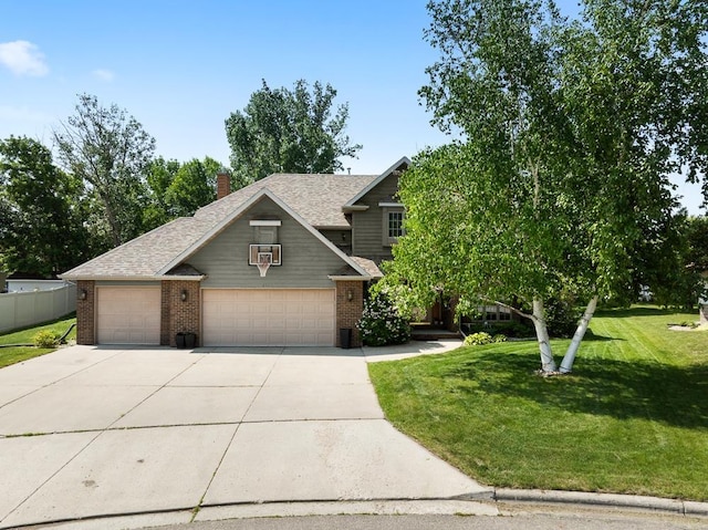 3304 12th St, Minot, ND 58701 - view of front of home with brick siding, concrete driveway, an attached garage, roof with shingles, and a chimney