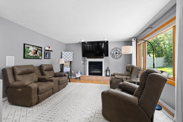 3304 12th St, Minot, ND 58701 - living area featuring light wood finished floors, baseboards, and a tiled fireplace