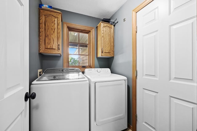 3304 12th St, Minot, ND 58701 - laundry room featuring washer and clothes dryer and cabinet space