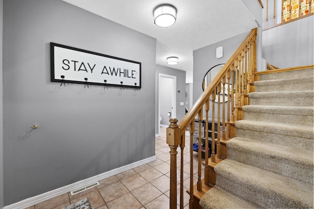 3304 12th St, Minot, ND 58701 - stairway with tile patterned flooring and baseboards