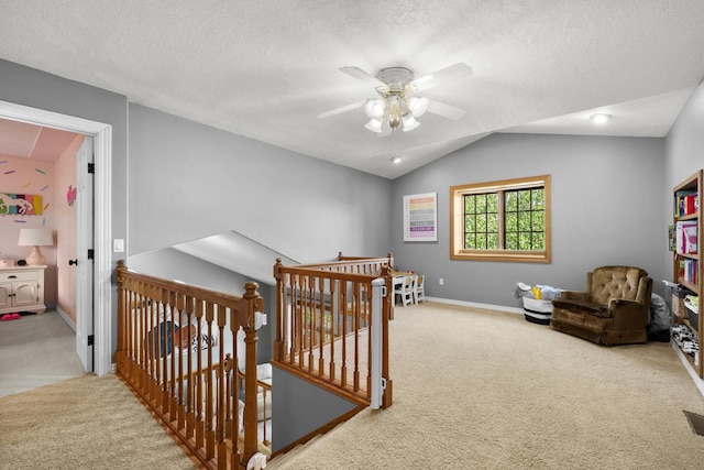 3304 12th St, Minot, ND 58701 - hall with an upstairs landing, carpet flooring, lofted ceiling, baseboards, and a textured ceiling