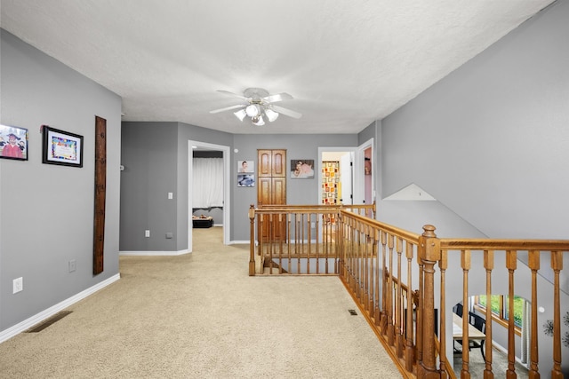3304 12th St, Minot, ND 58701 - hallway featuring an upstairs landing, baseboards, and carpet flooring