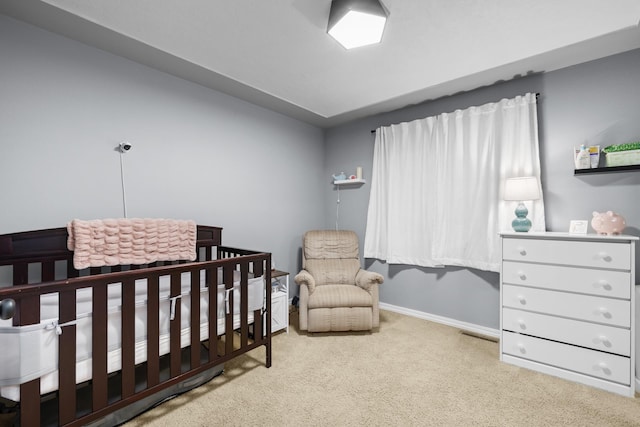 3304 12th St, Minot, ND 58701 - bedroom featuring carpet, a nursery area, and baseboards