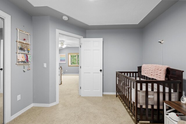 3304 12th St, Minot, ND 58701 - carpeted bedroom with baseboards and a crib