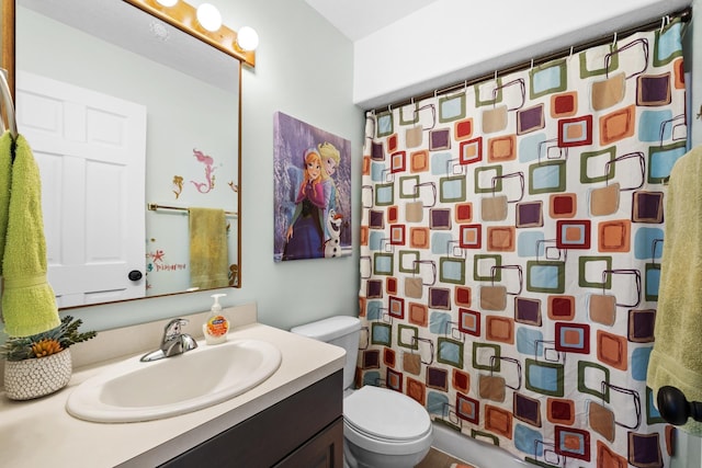 3304 12th St, Minot, ND 58701 - bathroom with toilet, vanity, and a shower with shower curtain