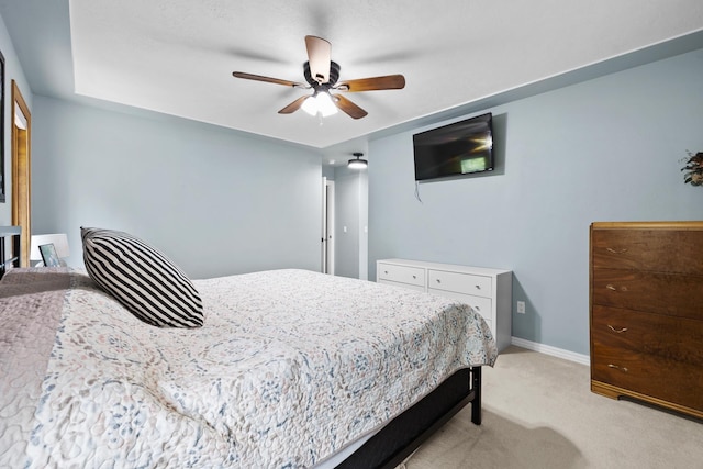 3304 12th St, Minot, ND 58701 - bedroom with light carpet, ceiling fan, and baseboards
