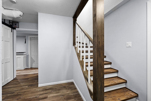 3304 12th St, Minot, ND 58701 - stairway featuring baseboards and wood finished floors