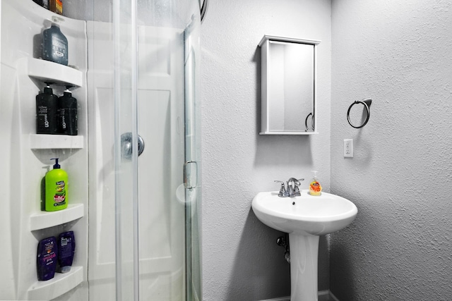 3304 12th St, Minot, ND 58701 - bathroom with a stall shower and a textured wall