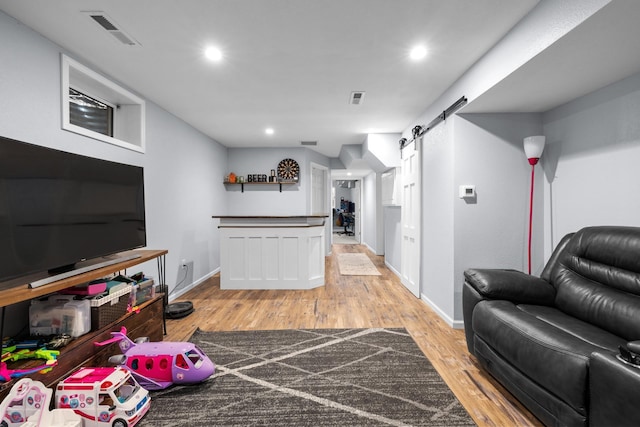 3304 12th St, Minot, ND 58701 - living area with a barn door, light wood-type flooring, recessed lighting, and baseboards