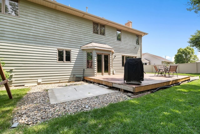 3304 12th St, Minot, ND 58701 - back of property with a chimney and a deck