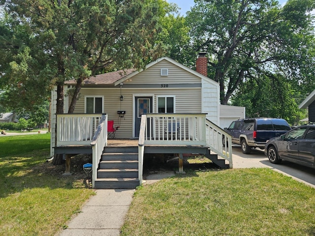 320 7th St, Minot, ND 58703 - view of front of home featuring a chimney, a front lawn, a wooden deck, and stairway