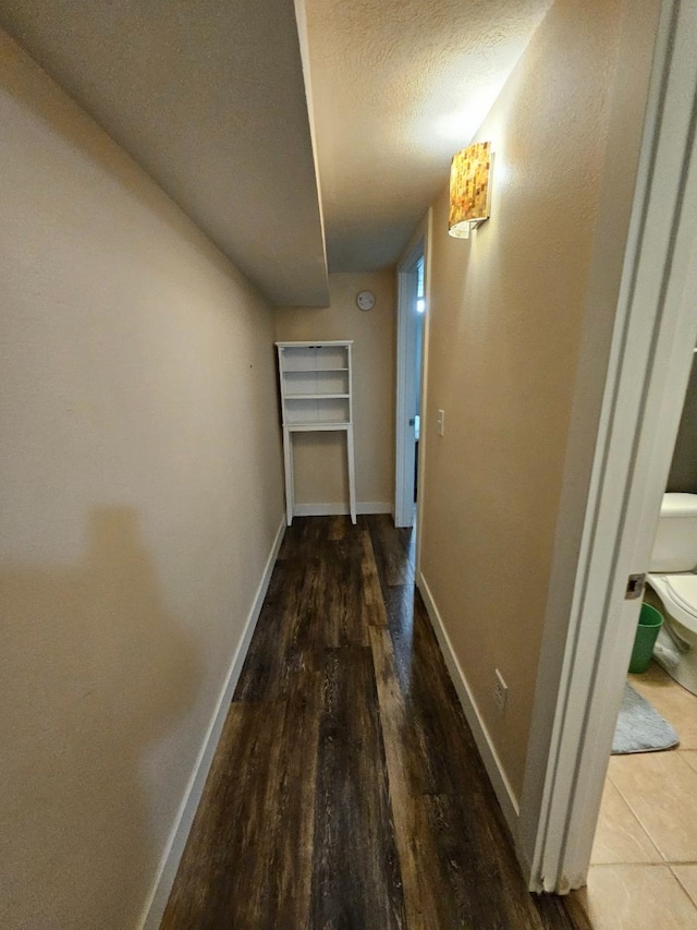 320 7th St, Minot, ND 58703 - hall with baseboards, wood finished floors, and a textured ceiling
