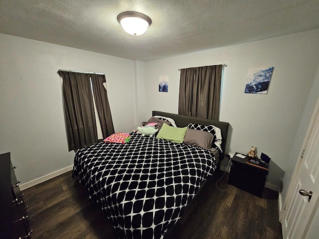 320 7th St, Minot, ND 58703 - bedroom featuring wood finished floors, baseboards, and a textured ceiling