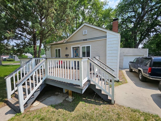 320 7th St, Minot, ND 58703 - back of house with a chimney, stairs, and a wooden deck