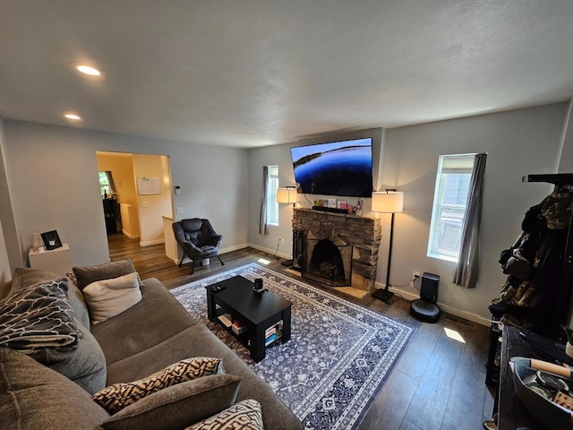 320 7th St, Minot, ND 58703 - living area with wood finished floors, a fireplace, recessed lighting, and baseboards