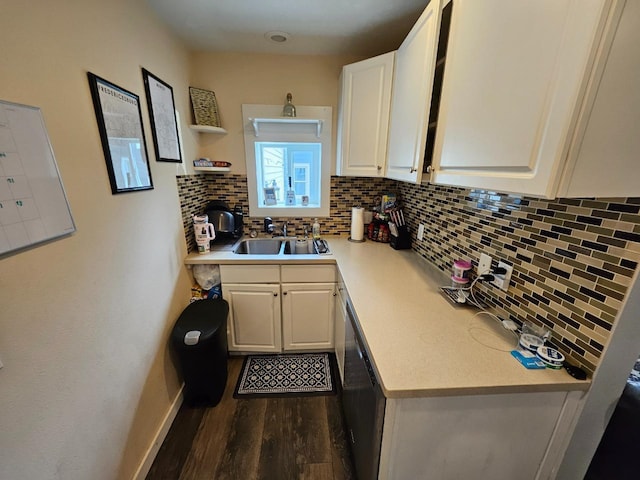 320 7th St, Minot, ND 58703 - kitchen featuring a sink, tasteful backsplash, dark wood-type flooring, white cabinets, and light countertops