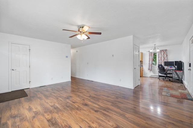 224 19th St, Minot, ND 58701 - unfurnished living room featuring a desk, wood finished floors, a ceiling fan, a chandelier, and a baseboard radiator