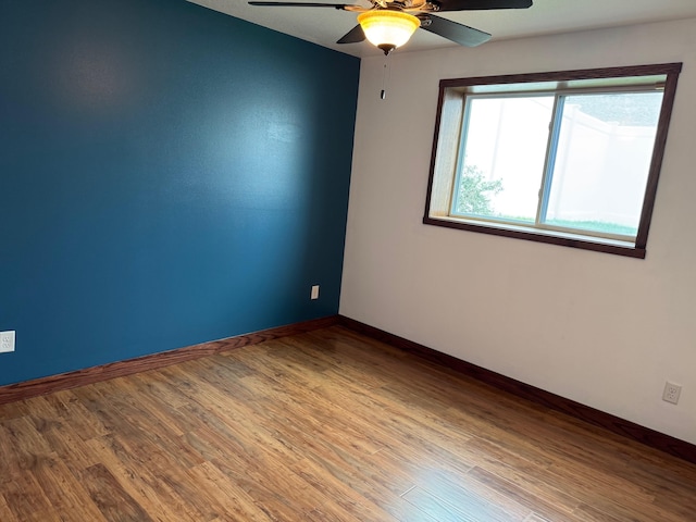 1400 34th Ave, Minot, ND 58701 - empty room featuring a ceiling fan and wood finished floors
