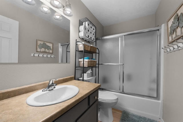 1705 SW Evergreen Ave, Minot, ND 58701 - bathroom with vanity, bath / shower combo with glass door, and wood finished floors
