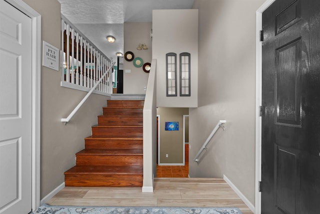 1705 SW Evergreen Ave, Minot, ND 58701 - stairway featuring wood finished floors and baseboards