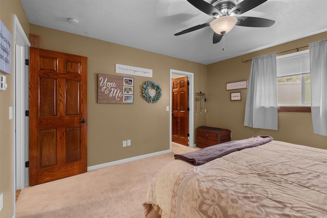 1705 SW Evergreen Ave, Minot, ND 58701 - carpeted bedroom with baseboards and a ceiling fan