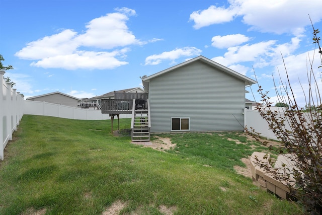 1705 SW Evergreen Ave, Minot, ND 58701 - back of property with stairs, a fenced backyard, and a deck