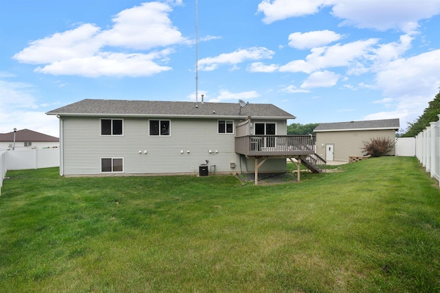 1705 SW Evergreen Ave, Minot, ND 58701 - back of house featuring a fenced backyard, stairs, and a deck