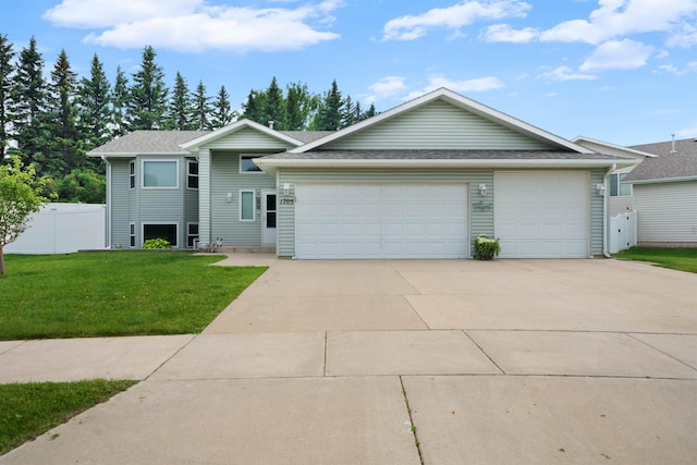 1705 SW Evergreen Ave, Minot, ND 58701 - view of front of home with a garage, driveway, and roof with shingles
