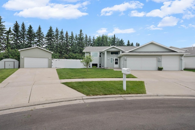 1705 SW Evergreen Ave, Minot, ND 58701 - view of front facade featuring a shed, a garage, and concrete driveway