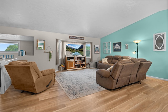 1705 SW Evergreen Ave, Minot, ND 58701 - living room featuring lofted ceiling, light wood-type flooring, and healthy amount of natural light