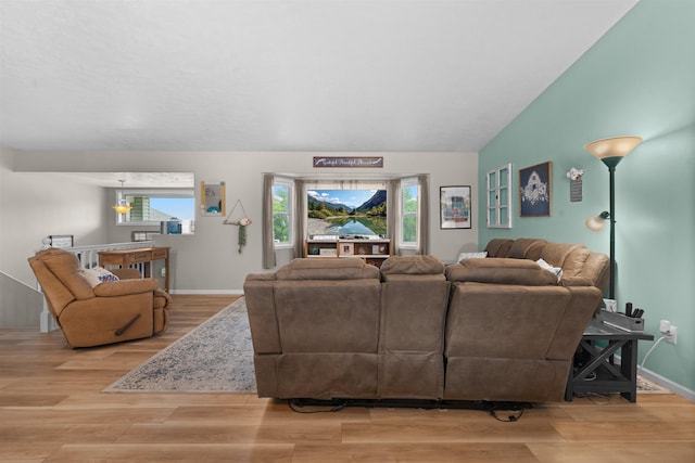 1705 SW Evergreen Ave, Minot, ND 58701 - living room featuring wood finished floors, healthy amount of natural light, and vaulted ceiling