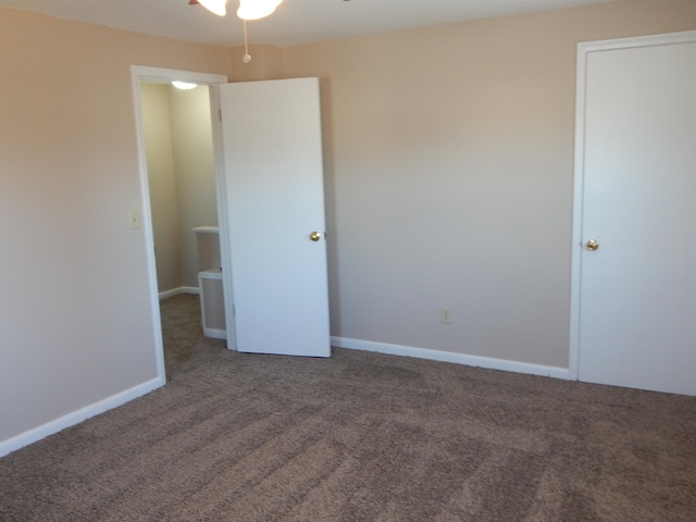 2014 4th St, Minot, ND 58703 - unfurnished bedroom with carpet floors and baseboards