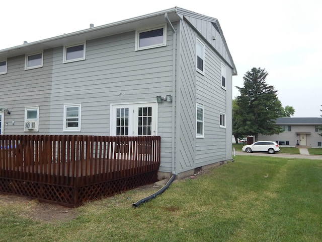 2014 4th St, Minot, ND 58703 - back of house with a lawn, a wooden deck, and french doors
