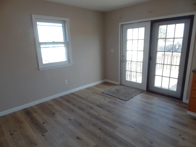 2014 4th St, Minot, ND 58703 - doorway with baseboards and wood finished floors