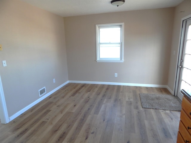 2014 4th St, Minot, ND 58703 - empty room with wood finished floors and baseboards