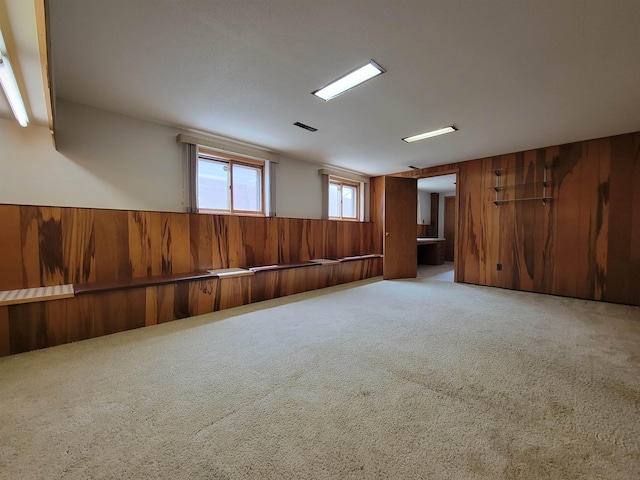 1000 21st St, Minot, ND 58703 - unfurnished room with carpet floors, wooden walls, and wainscoting
