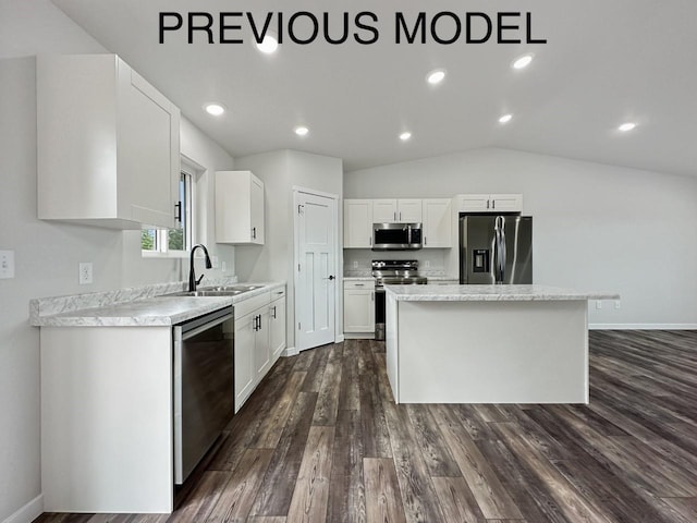 336 7th Ave, Surrey, ND 58785 - kitchen with appliances with stainless steel finishes, a center island, light countertops, dark wood-type flooring, and vaulted ceiling