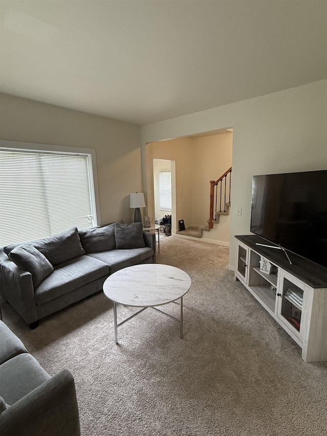 510 4th St, Minot, ND 58703 - living area with carpet, stairway, and plenty of natural light