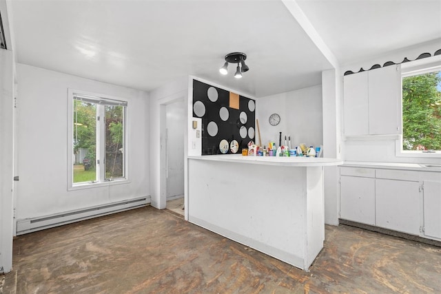 306 2nd St, Towner, ND 58788 - bar with baseboard heating, concrete flooring, and plenty of natural light