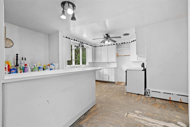 306 2nd St, Towner, ND 58788 - kitchen featuring baseboard heating, white cabinets, ceiling fan, a peninsula, and open shelves