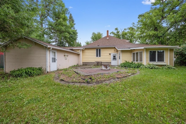 306 2nd St, Towner, ND 58788 - rear view of house with a patio, a yard, and a chimney
